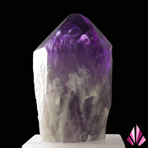 Brazilian amethyst crystal with a purple termination presented on an acrylic stand